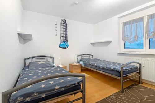 a bedroom with two beds and a window at Ferienwohnung Rheinvorland in Linx