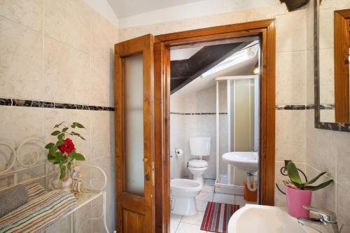 a bathroom with a toilet and a sink and a mirror at Villa Bella Vista in Imperia