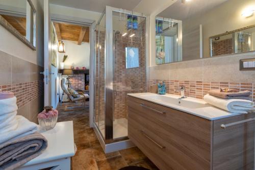 a bathroom with a sink and a shower at La Casa di Valverde in Alghero