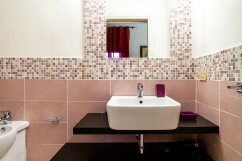 a bathroom with a sink and a mirror at Palmiro in Castiglione della Pescaia