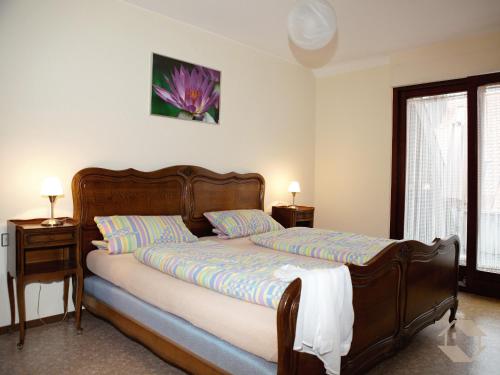 a bedroom with a bed and a flower on the wall at Schmiede Burkheim in Vogtsburg