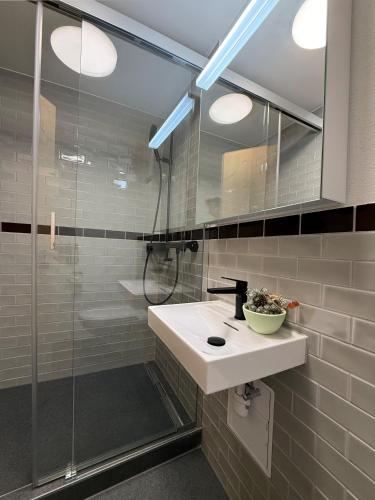 a bathroom with a sink and a shower at Stylish Aurora Studio with Mountain Views Lenzerheide in Lenzerheide