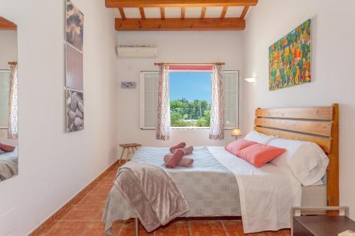 a bedroom with a bed with a teddy bear on it at Racó Blau in Cap d'en Font