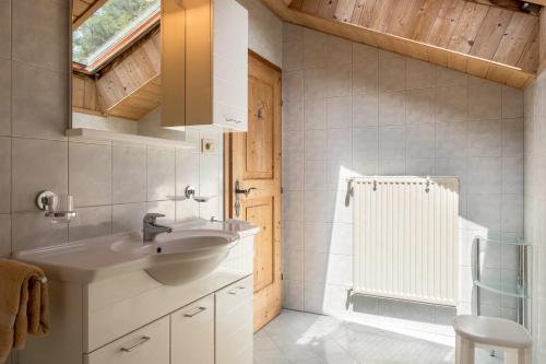a bathroom with a sink and a shower at Gamperhof Apartment Latemar in Collepietra