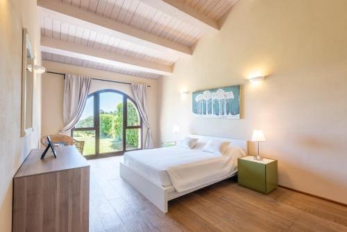 a bedroom with a bed and a large window at Villa Falco in Trequanda