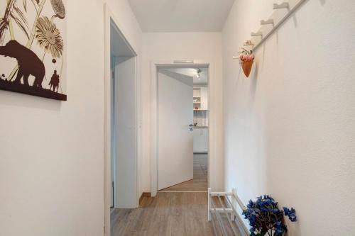 a hallway of a home with white walls and wooden floors at Ferienwohnung Griaß di in Salgen