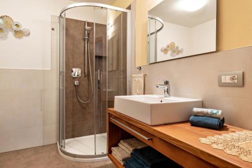 a bathroom with a sink and a shower at Ciasa Rungg Monte Sella Suite in San Vigilio Di Marebbe
