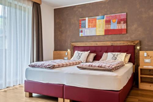 a bedroom with two beds in a room at Ciasa Rungg Monte Sella Suite in San Vigilio Di Marebbe