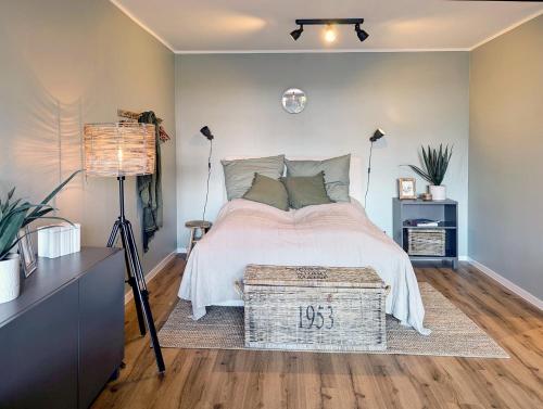 a bedroom with a bed with a table and lamps at Ferienwohnung Nautilus in Heiligenhafen