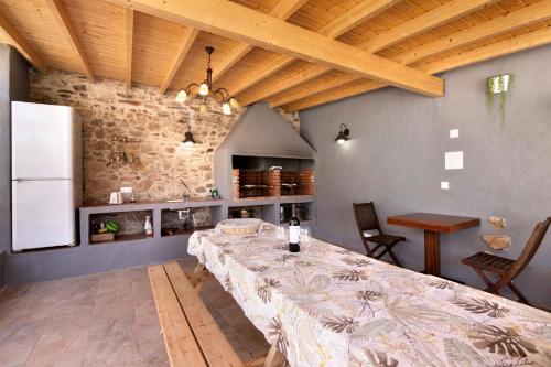 a dining room with a table and a kitchen at Quinta do Silêncio T2 in Tavira