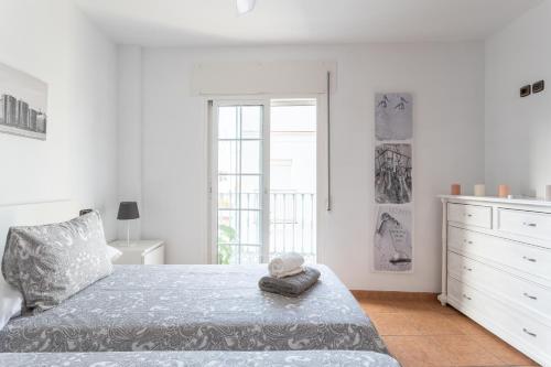a bedroom with a bed with a stuffed animal on it at Apartamento San Juan 18 in Nerja