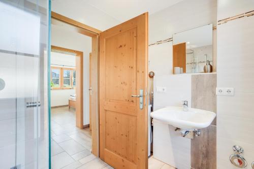 a bathroom with a sink and a mirror at Ferienwohnung Bergblick in Bad Heilbrunn