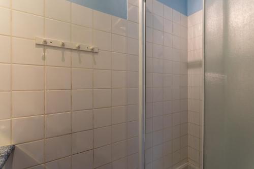 a shower with a glass door in a bathroom at La maison de vacances Mathieu in Artigues