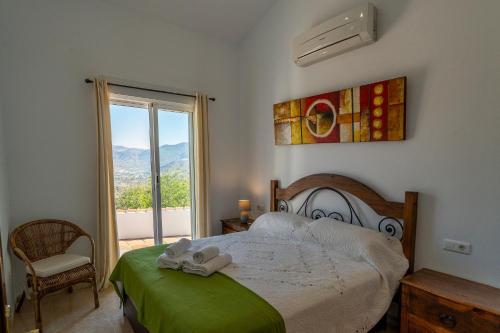 a bedroom with a bed with towels on it at Bravo spectacular views in Viñuela