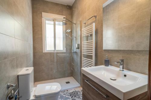 a bathroom with a sink and a shower and a toilet at Bravo spectacular views in Viñuela