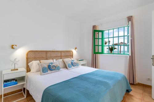 a bedroom with a bed and a window at Bungalow Alma Ocean View in Puerto del Carmen