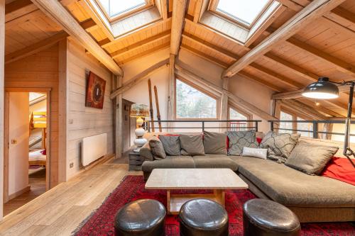 a living room with a couch and a table at Le Galetas in Brides-les-Bains