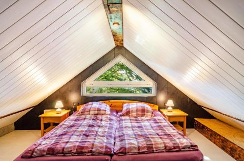 a bed in a tiny house with a window at Ferienwohnung Klee 2 in Fedderwarden