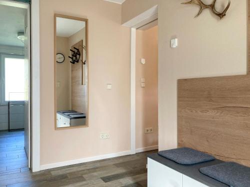 a living room with a mirror and a bench at Bungalow 314 in Joachimsthal
