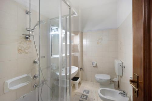 a bathroom with a shower and a toilet and a sink at Appartamento Orizzonte 8 B in Diano Marina