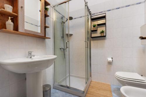 a bathroom with a shower and a sink and a toilet at New Casa Di Tino in Brenzone sul Garda