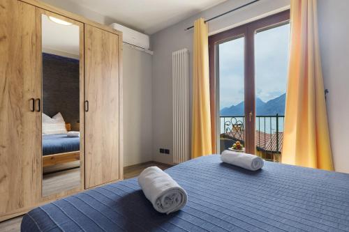a bedroom with a bed with two towels on it at New Casa Di Tino in Brenzone sul Garda