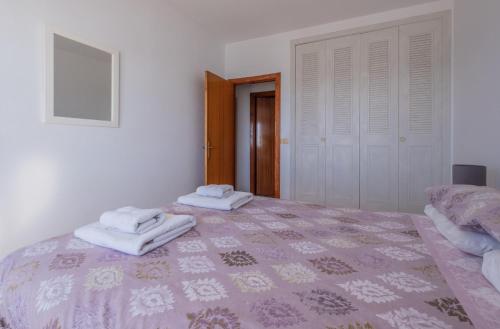 a bedroom with two towels sitting on a bed at Flat3-5 Chaparil Beach in Nerja