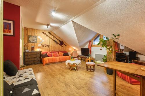 a living room with a couch and a table at L'Edelweiss in Saint-Pierre-de-Chartreuse