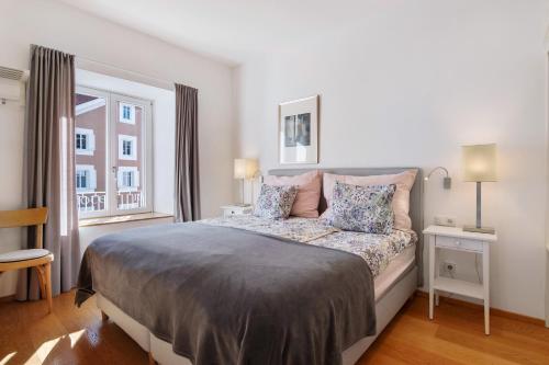 a bedroom with a large bed and a window at Sommavilla Apartments in Silandro