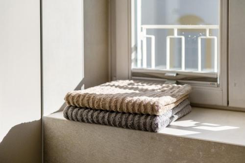 a stack of towels sitting on a window sill at Sommavilla Apartments in Silandro