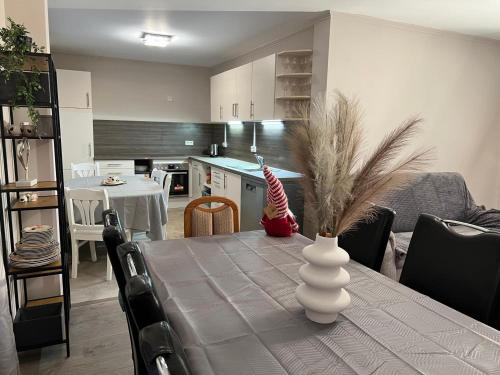 a kitchen and dining room with a table with a vase at Schöne Wohnung Mit Dem Garten in Jübek