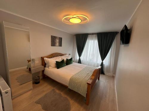 a bedroom with a bed and a large window at Private Entrance En-suite in Gorey
