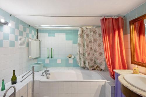 a bathroom with a tub and a shower and a sink at Azenha da Lagoa Negra in Barqueiros