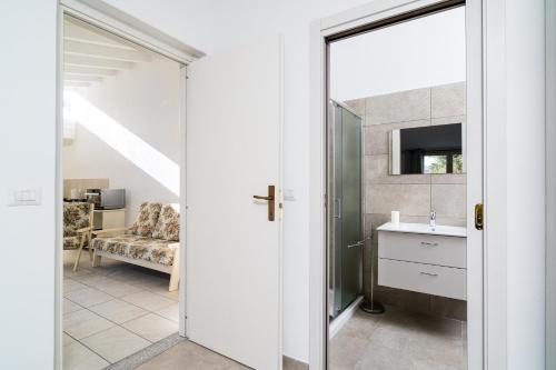 a bathroom with a sink and a mirror at Domo Bonaeras in Irgoli