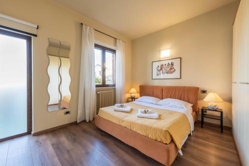a bedroom with a large bed and a window at Casa Vacanze Matisse in Toscolano Maderno