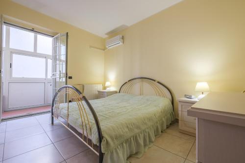 a bedroom with a bed and a window at Casa a 100 mt Dal Mare in SantʼAlessio Siculo