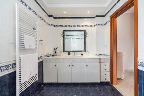 a bathroom with a sink and a mirror at Rafaela's House 2 in Koskinou