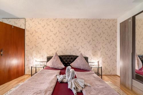 a bedroom with a large bed with towels on it at Ferienwohnung in der Eifel in Pesch