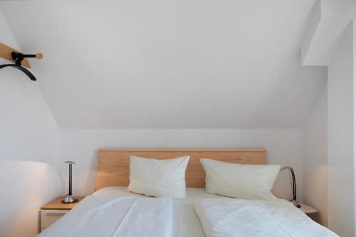 a bedroom with two beds with white sheets and pillows at Ferienwohnung Tannenblick 7-5 in Oberhof