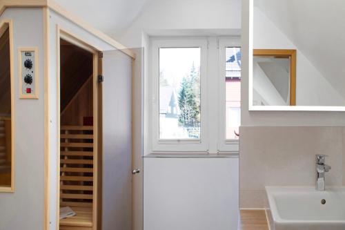 a bathroom with a sink and a window at Ferienwohnung Tannenblick 7-5 in Oberhof