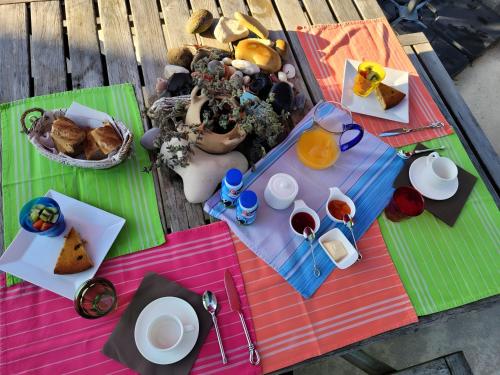 a picnic table with food and drinks on it at Chambre D'hôtes À 2 Pas Des Plages in Notre-Dame-de-Riez