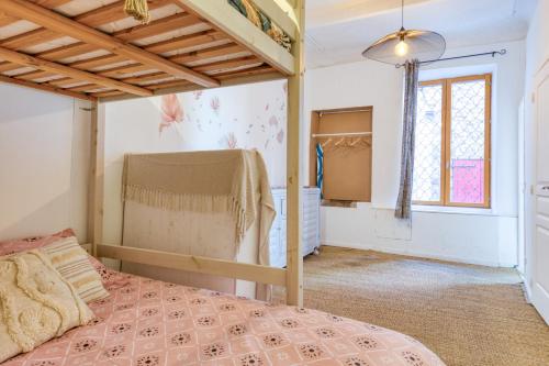 a bedroom with a bed and a window at Agde Heritage, No. 16 in Agde