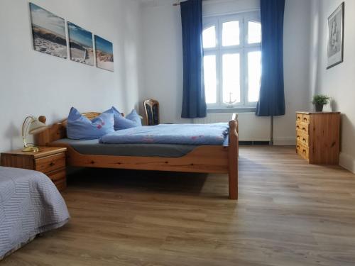 a bedroom with a bed and a large window at Villa Adler- Seeblick in Ahlbeck