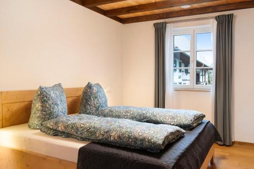 a chair sitting on a couch next to a window at Landluft Ferien - Wohnung Morgentau in Heiligenberg
