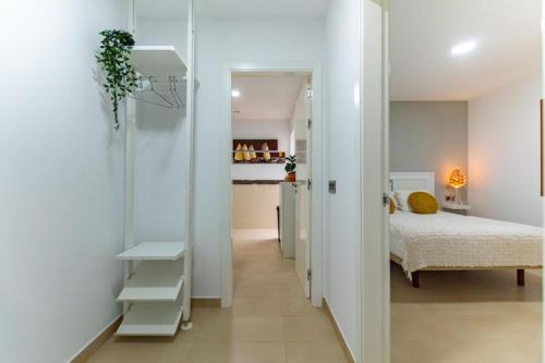 a bedroom with a bed and a walk in closet at Eclipse in Puerto del Rosario