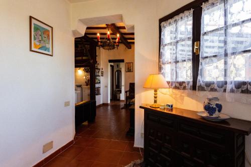 a hallway of a home with a table and a lamp at Casa Country in Capoliveri