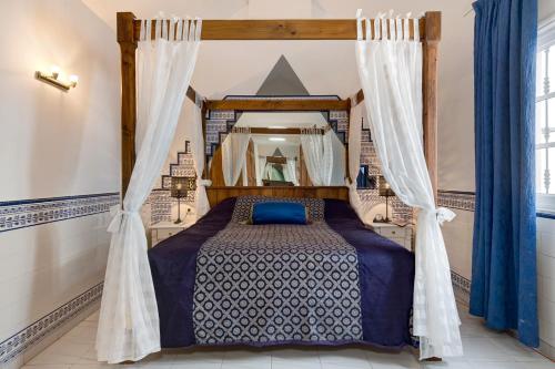 a bedroom with a bed with a canopy at Casa Colleen in Puerto del Carmen