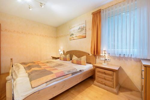 a bedroom with a large bed and a window at Ferienwohnung Baier in Überlingen