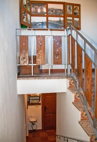 a staircase in a house with glass railing at Casa Mariano in Turégano