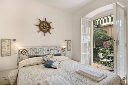 a bedroom with a bed with a clock on the wall at Oceane Paradise - Churchill in Levanto